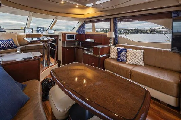 Slide: The Image of Luxurious interior of a 2005 Sea Ray 520 Sedan Bridge yacht with elegant seating and dining area. - 32