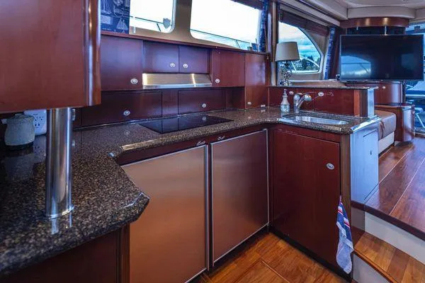 Slide: The Image of Luxurious kitchen interior of 2005 Sea Ray 520 Sedan Bridge yacht with modern amenities. - 36