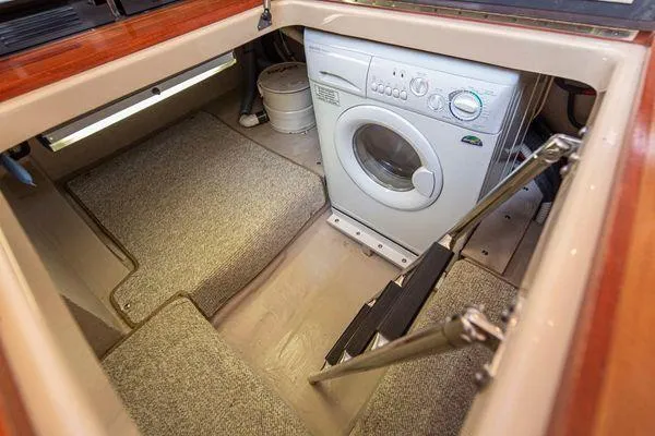 Slide: The Image of Laundry area with washing machine in 2005 Sea Ray 520 Sedan Bridge yacht. - 38