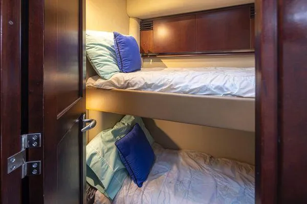Slide: The Image of Bunk beds in 2005 Sea Ray 520 Sedan Bridge yacht cabin with blue pillows. - 44