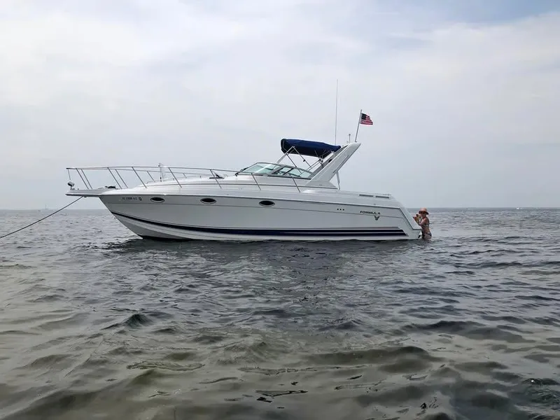 Slide: The Image of 2002 Formula 31 PC boat on calm water with American flag. - 0