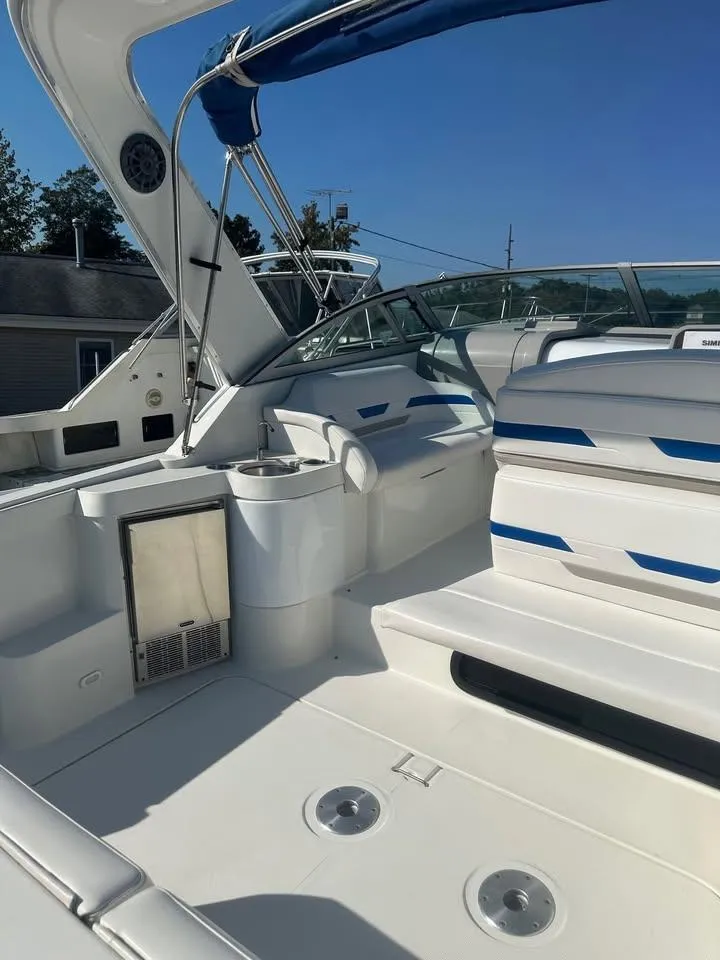 Slide: The Image of 2002 Formula 31 PC boat interior with seating and blue accents under clear sky. - 3