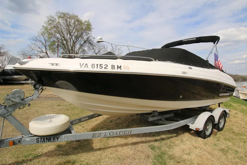 The Image of 2007 Chaparral 204 SSi boat on trailer, black and white design, parked on grass. - 0
