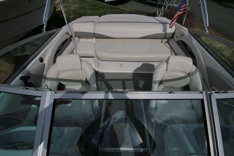 Slide: The Image of 2007 Chaparral 204 SSi boat interior with beige seating and American flag. - 12