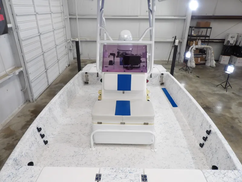 Slide: The Image of 2022 Freedom 18 PATRIOT boat interior in a well-lit garage setting. - 10