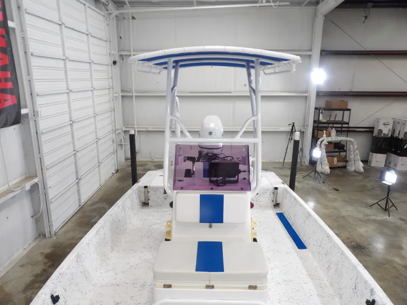 Slide: The Image of 2022 Freedom 18 PATRIOT boat in a warehouse, featuring a blue and white interior. - 11