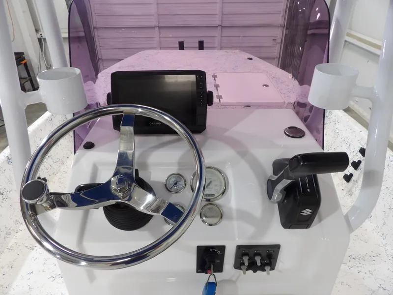 Slide: The Image of 2022 Freedom 18 PATRIOT boat dashboard with steering wheel, gauges, and controls. - 13