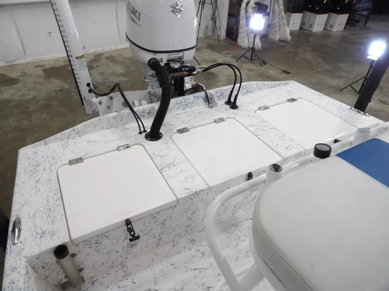 Slide: The Image of 2022 Freedom 18 PATRIOT boat interior with Suzuki motor and storage compartments. - 16