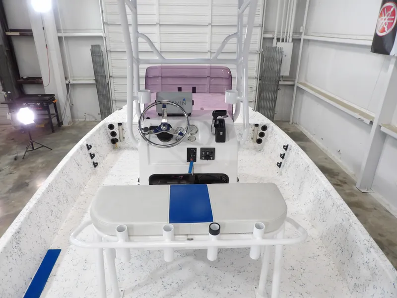 Slide: The Image of 2022 Freedom 18 PATRIOT boat interior with steering console in a garage setting. - 19