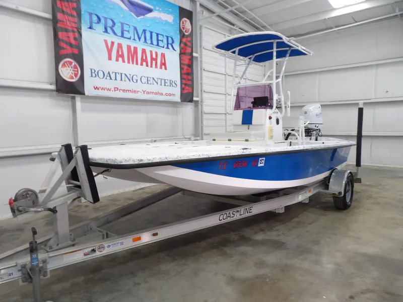 Slide: The Image of 2022 Freedom 18 PATRIOT boat on trailer in indoor showroom. - 3