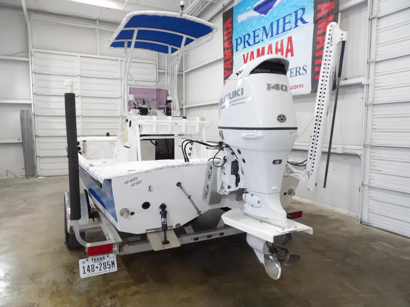 Slide: The Image of 2022 Freedom 18 PATRIOT boat with Suzuki 140 outboard motor in a showroom. - 6