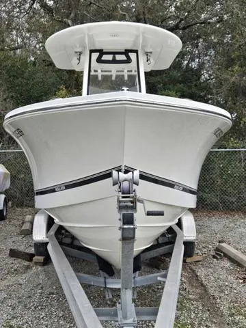 Slide: The Image of 2020 Regulator 23 boat on trailer, front view, parked outdoors. - 3