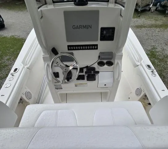Slide: The Image of 2020 Regulator 23 boat cockpit with Garmin navigation system and steering wheel. - 7