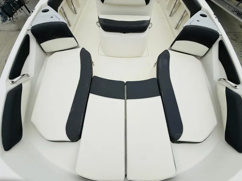 Slide: The Image of 2019 Stingray 206 CC boat interior with black and white seating arrangement. - 3