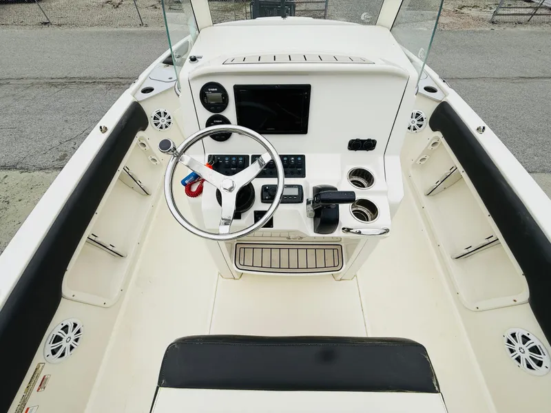 Slide: The Image of 2019 Stingray 206 CC boat cockpit with steering wheel and control panel. - 4