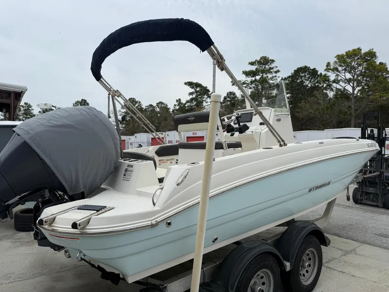 Slide: The Image of 2019 Stingray 206 CC boat on trailer, featuring a covered outboard motor. - 6