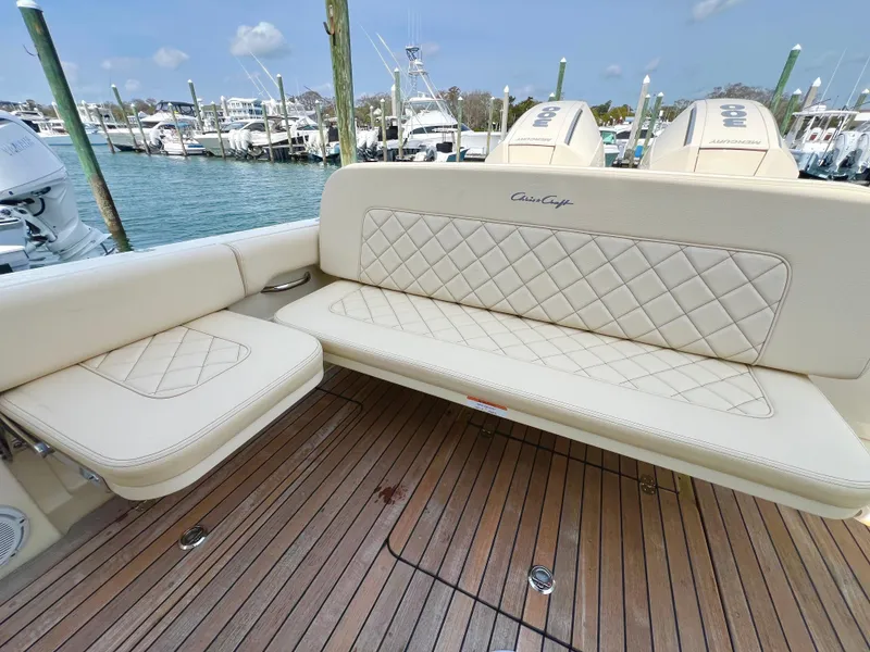 Slide: The Image of 2022 Chris-Craft Calypso 30 boat with elegant seating and teak deck at marina. - 10