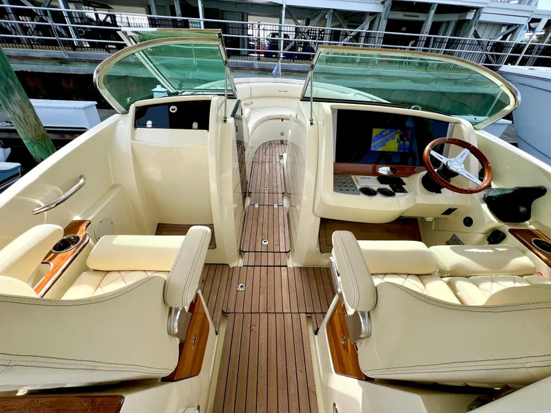 Slide: The Image of 2022 Chris-Craft Calypso 30 boat interior with luxurious seating and wooden accents. - 12