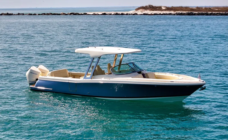 Slide: The Image of 2022 Chris-Craft Calypso 30 boat on clear blue water, side view. - 18