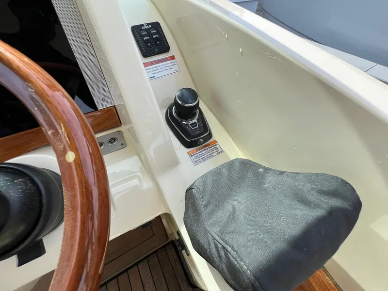 Slide: The Image of 2022 Chris-Craft Calypso 30 helm with joystick control and wooden steering wheel. - 19
