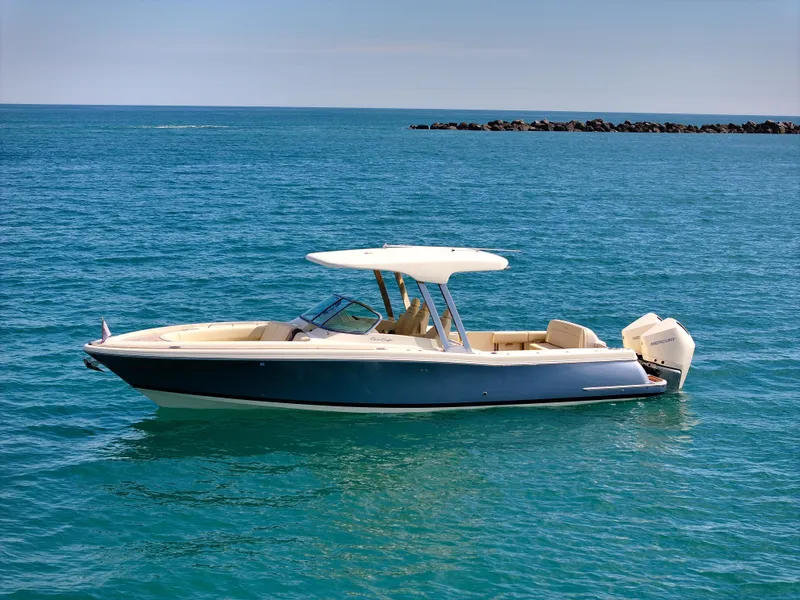 Slide: The Image of 2022 Chris-Craft Calypso 30 boat on calm blue ocean waters. - 2