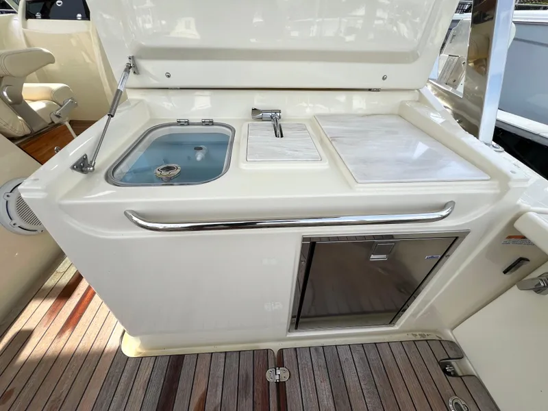 Slide: The Image of 2022 Chris-Craft Calypso 30 boat kitchenette with sink, faucet, and storage. - 20