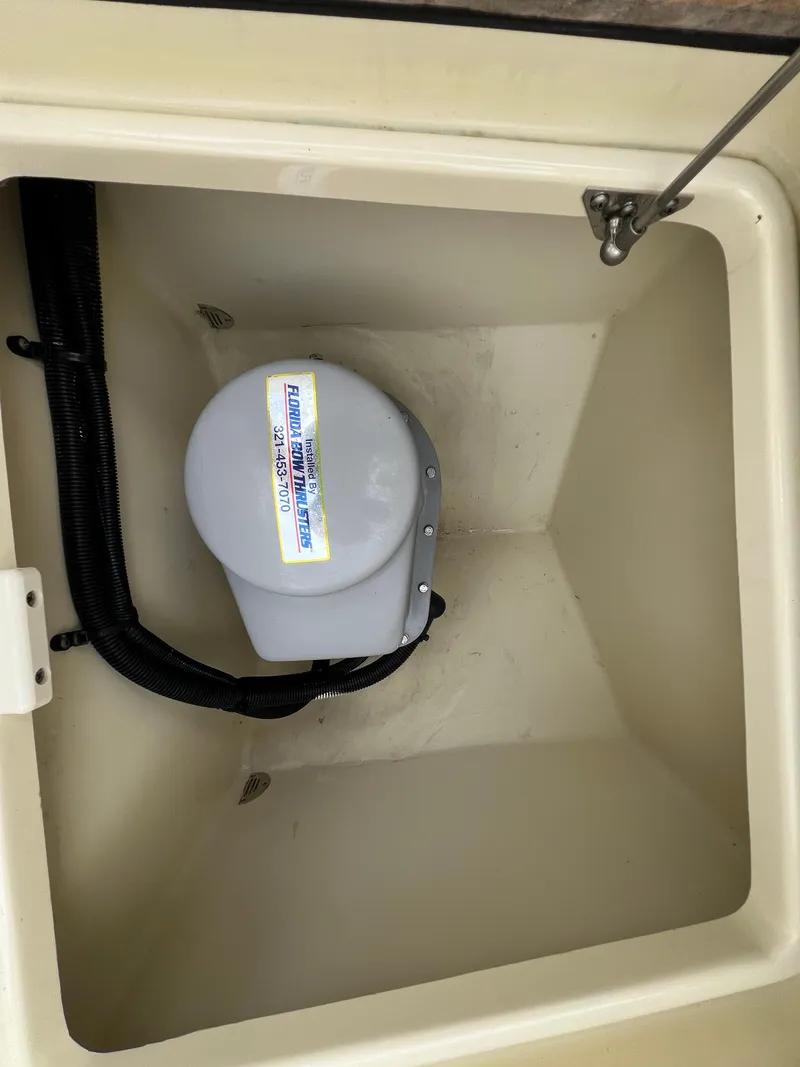 Slide: The Image of Storage compartment in a 2022 Chris-Craft Calypso 30 boat, featuring a mounted device. - 26