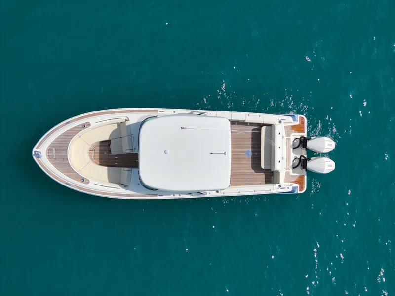 Slide: The Image of 2022 Chris-Craft Calypso 30 boat, aerial view, on clear blue water. - 4