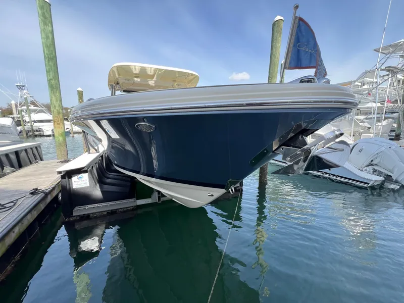 Slide: The Image of 2022 Chris-Craft Calypso 30 boat docked in marina, blue hull, sunny day. - 6