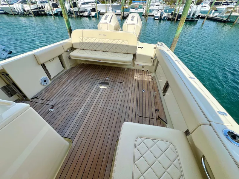 Slide: The Image of 2022 Chris-Craft Calypso 30 boat with teak deck and cushioned seating in marina. - 7