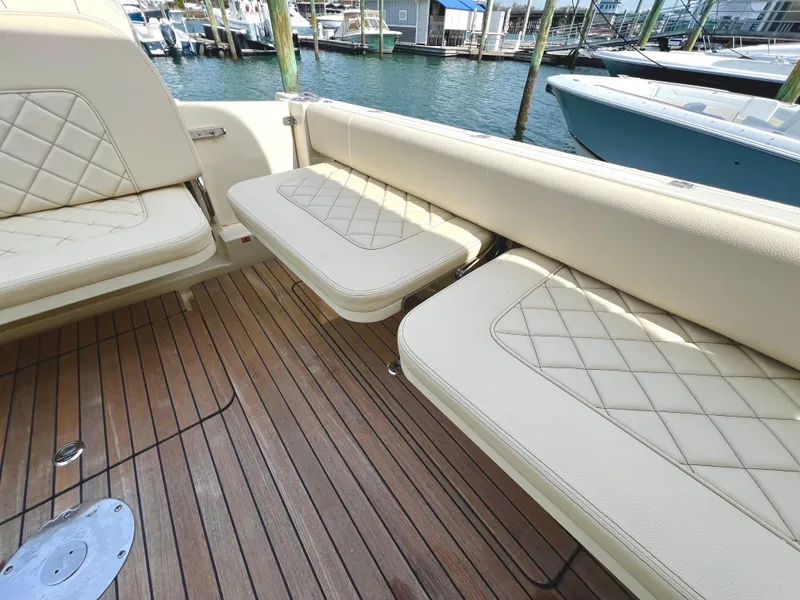 Slide: The Image of 2022 Chris-Craft Calypso 30 boat interior with beige seating and wooden deck. - 8