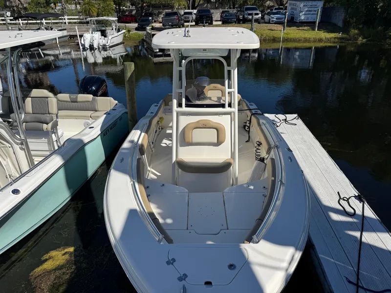 Slide: The Image of 2019 Key West 219 FS boat docked at marina, featuring spacious seating and sleek design. - 1