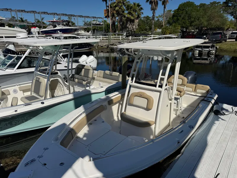 Slide: The Image of 2019 Key West 219 FS boat docked, featuring sleek design and spacious seating. - 2