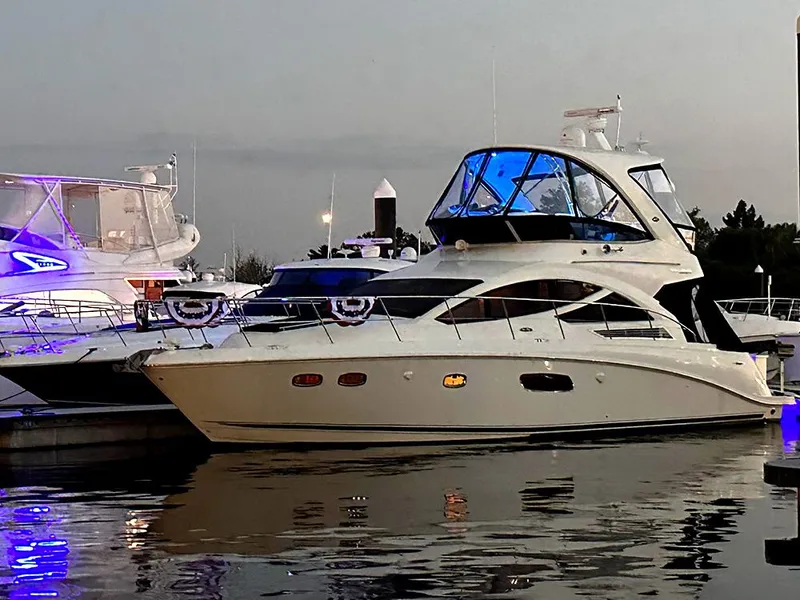 The Image of 2013 Sea Ray 450 Sedan Bridge yacht docked at marina during twilight. - 1