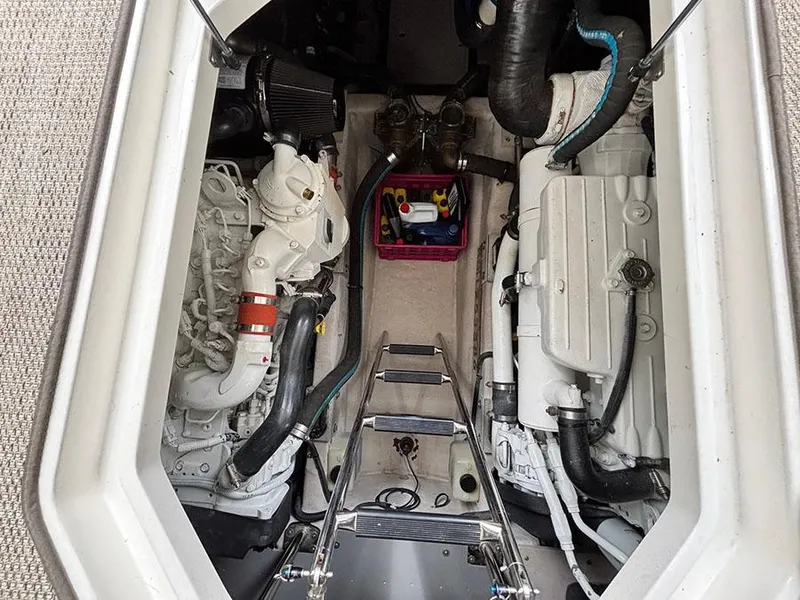 Slide: The Image of Engine room of 2013 Sea Ray 450 Sedan Bridge with visible components and ladder. - 16