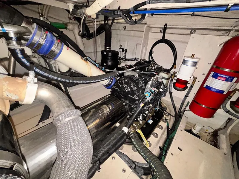 Slide: The Image of Engine room of 2013 Sea Ray 450 Sedan Bridge with visible components and fire extinguisher. - 17