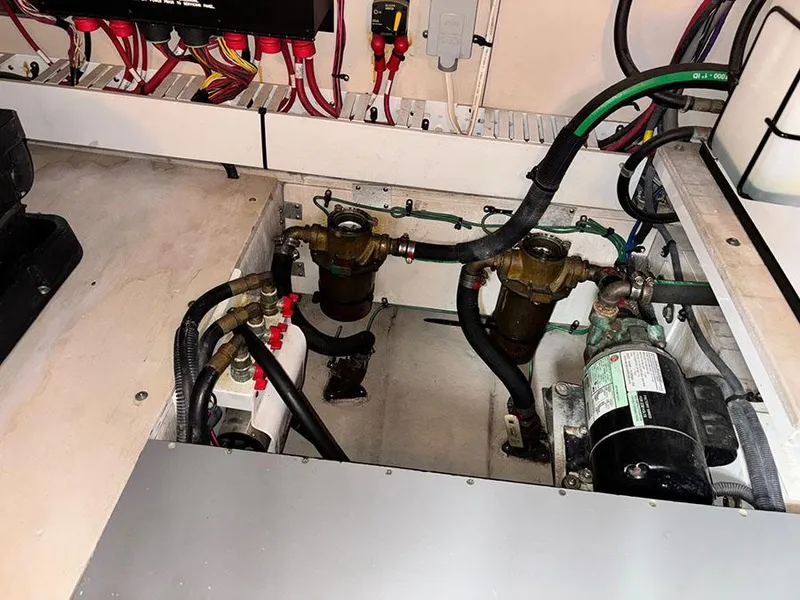 Slide: The Image of Engine compartment of a 2013 Sea Ray 450 Sedan Bridge with visible wiring and components. - 24