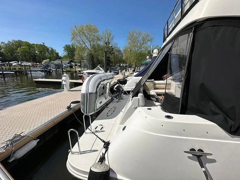 Slide: The Image of 2013 Sea Ray 450 Sedan Bridge yacht docked at marina, sunny day, clear blue sky. - 3