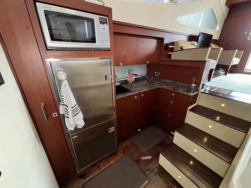 Slide: The Image of Interior of 2013 Sea Ray 450 Sedan Bridge yacht with kitchen and stairs. - 33