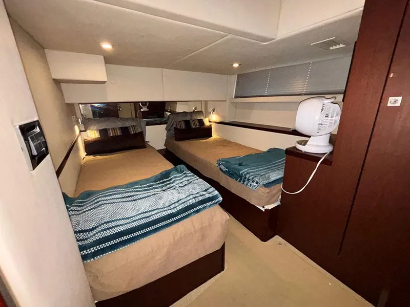 Slide: The Image of Interior cabin of 2013 Sea Ray 450 Sedan Bridge with twin beds and modern decor. - 39
