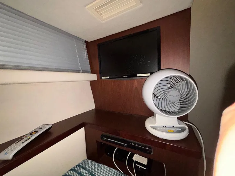 Slide: The Image of Interior of 2013 Sea Ray 450 Sedan Bridge with TV, fan, and remote control. - 41