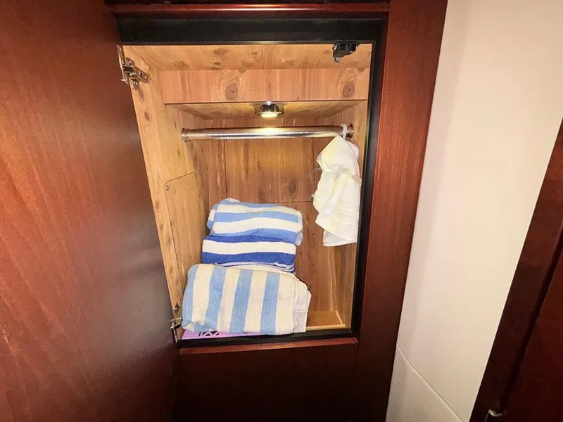 Slide: The Image of Cabinet with towels inside a 2013 Sea Ray 450 Sedan Bridge yacht. - 48