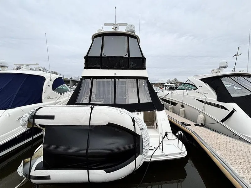 Slide: The Image of 2013 Sea Ray 450 Sedan Bridge yacht docked with inflatable boat attached. - 6