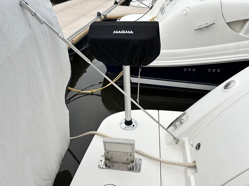 Slide: The Image of Sea Ray 450 Sedan Bridge 2013 with Magma grill on deck, docked at marina. - 9