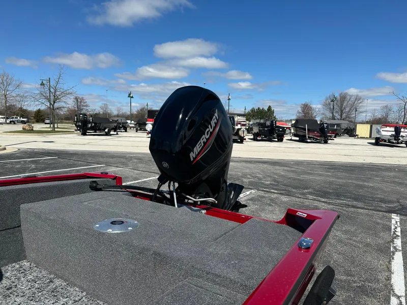 Slide: The Image of 2025 Tracker Super Guide V-16 SC boat with Mercury engine in parking lot. - 4