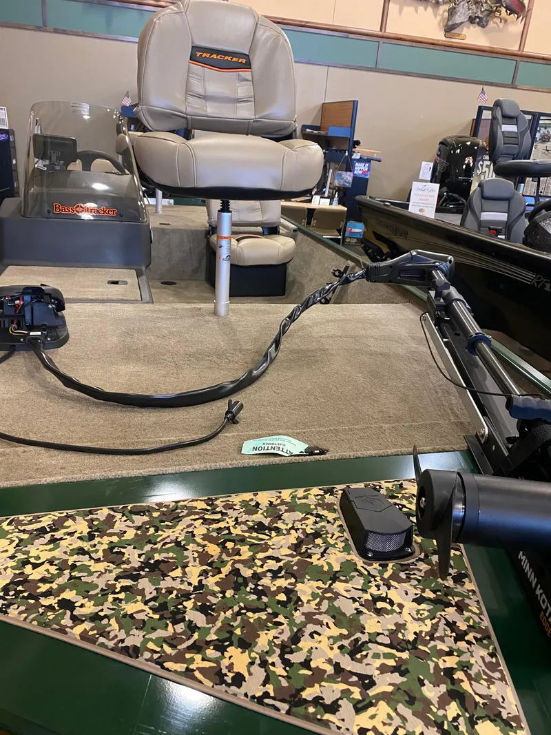 Slide: The Image of 2025 Tracker Bass Tracker Classic Limited boat interior with camouflage deck and seating. - 3