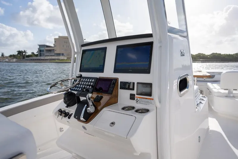 Slide: The Image of 2025 Caymas 291 HB boat dashboard with modern navigation screens and controls. - 11