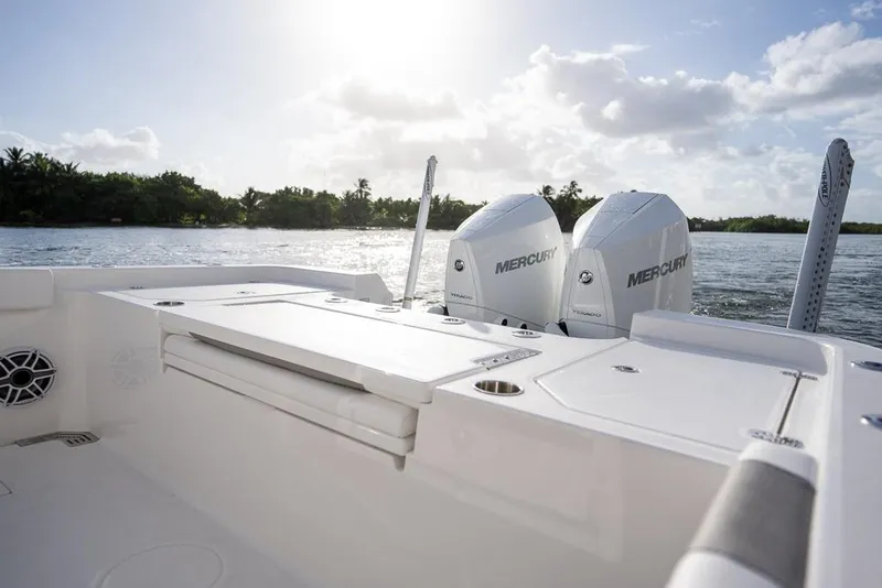 Slide: The Image of 2025 Caymas 291 HB boat with dual Mercury engines on a sunny day. - 16