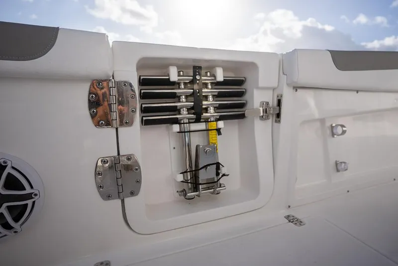 Slide: The Image of 2025 Caymas 291 HB boat compartment with mechanical components and hinges, under a bright sky. - 20