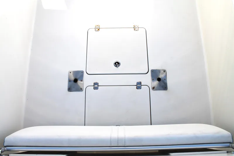 Slide: The Image of 2018 Andros 26 Tarpon boat interior with storage compartment and cushioned seat. - 11